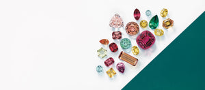 coloured gemstones placed on a white background in a variety of shapes and sizes ready to be used in jewelry