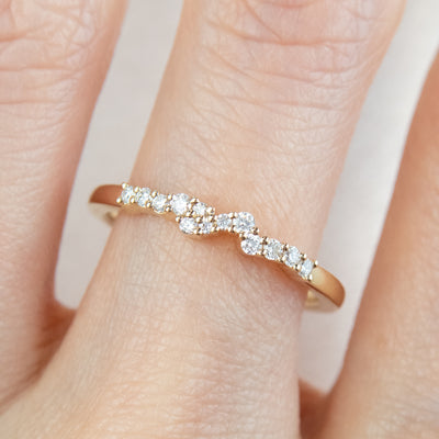 An exquisite gold ring embellished with diamonds, reflecting a timeless elegance and opulence. Worn on  finger.