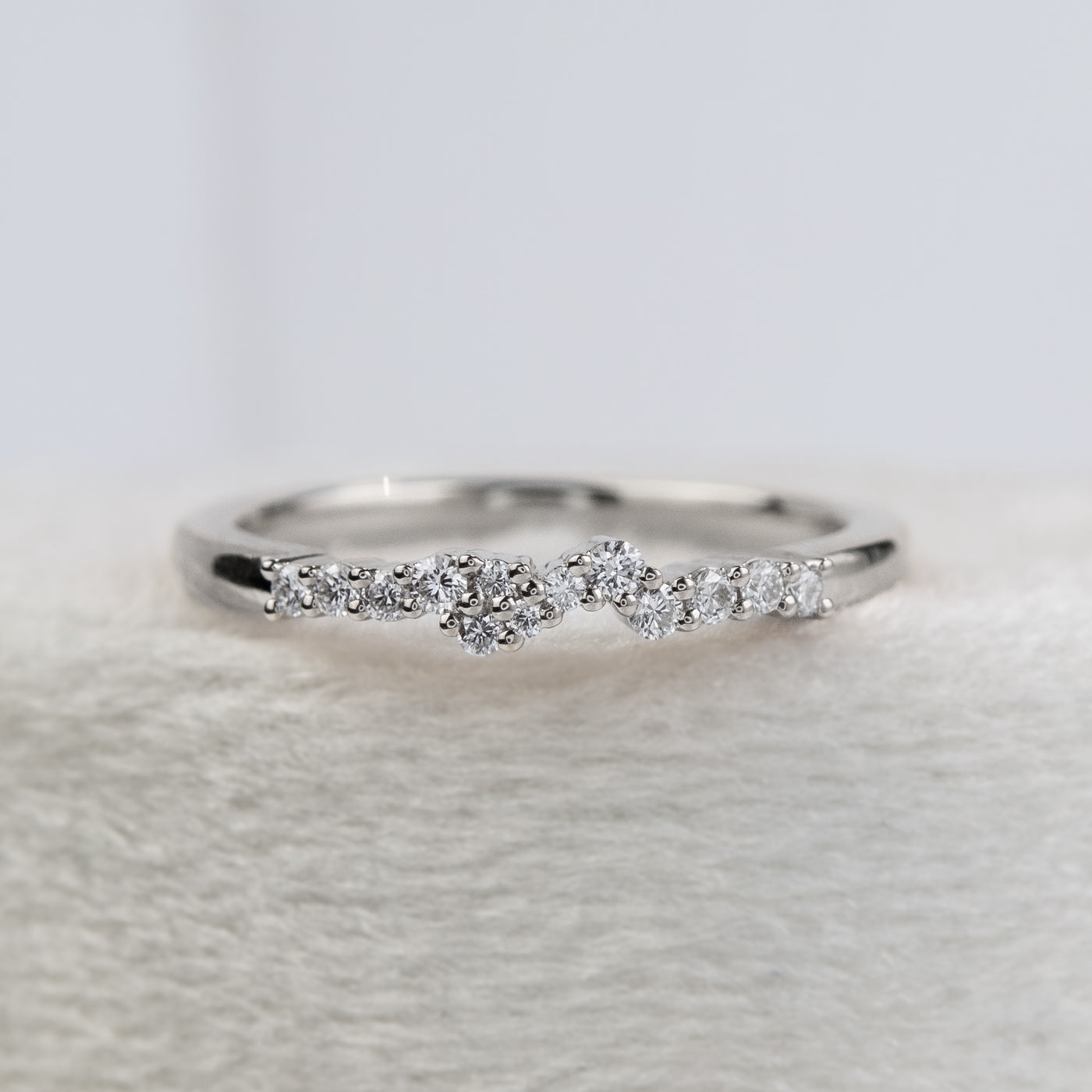 An exquisite white gold ring embellished with diamonds, reflecting a timeless elegance and opulence.