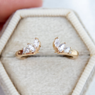A unique 14KT yellow gold open ring with a combination of Round and Marquise Diamonds, shown in a light coloured velvet box. 