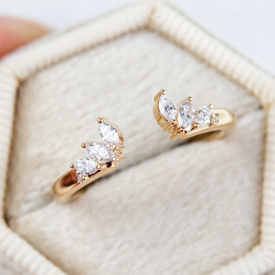A unique 14KT yellow gold open ring with a combination of Round and Marquise Diamonds, shown in a light coloured velvet box. 