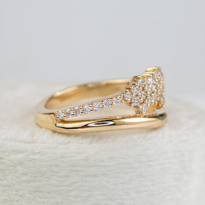 A beautiful gold ring featuring shimmering diamonds and a split band, perfect as a wedding band or for adding a touch of glamour to any outfit