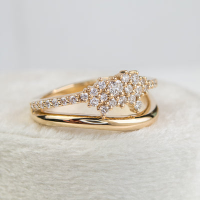 A beautiful gold ring featuring shimmering diamonds and a split band, perfect as a wedding band or for adding a touch of glamour to any outfit