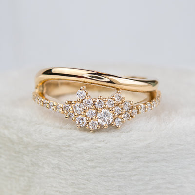 A beautiful gold ring featuring shimmering diamonds and a split band, perfect as a wedding band or for adding a touch of glamour to any outfit
