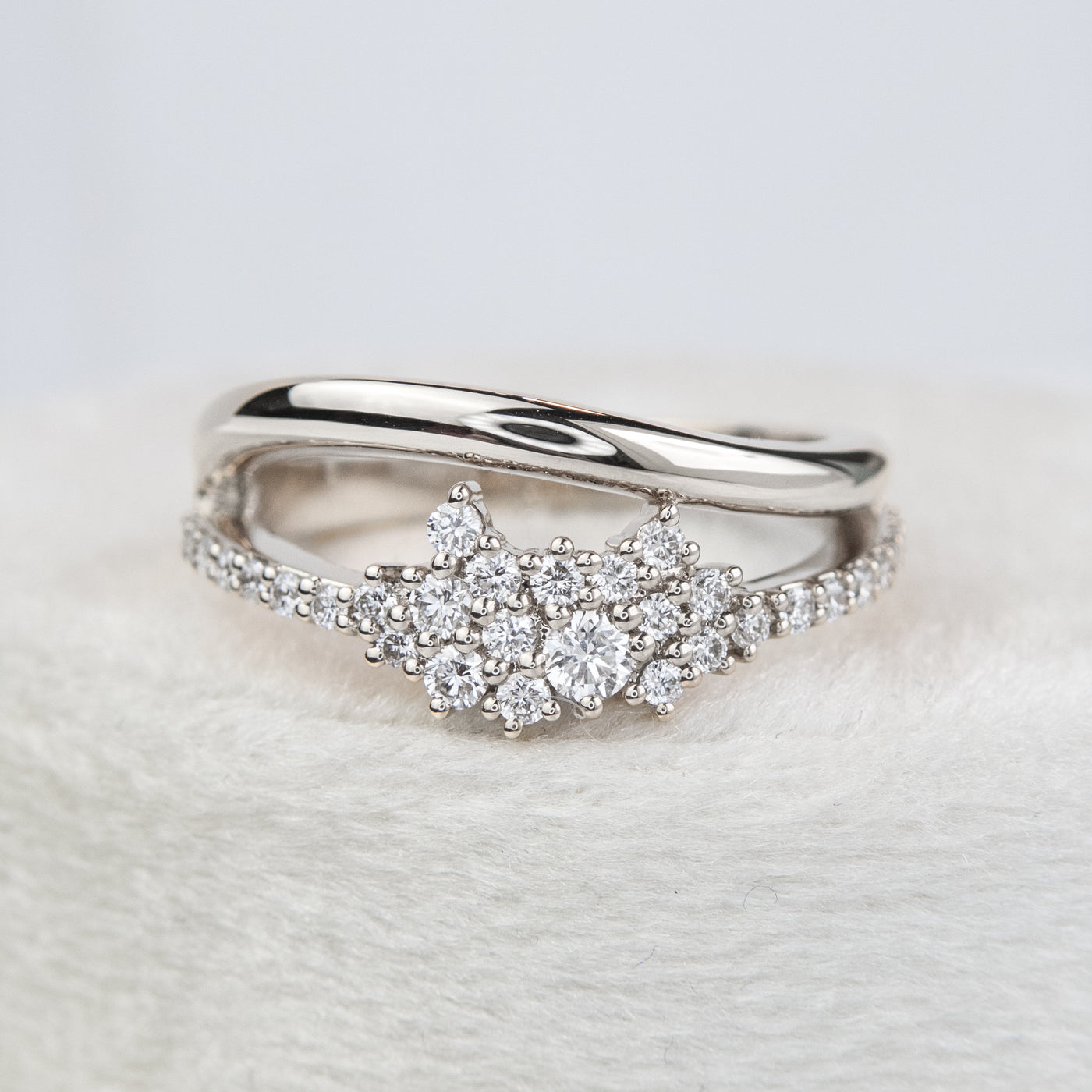 A beautiful white gold ring featuring shimmering diamonds and a split band, perfect as a wedding band or for adding a touch of glamour to any outfit