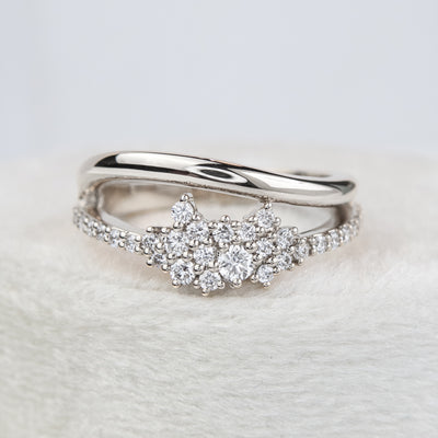 A beautiful white gold ring featuring shimmering diamonds and a split band, perfect as a wedding band or for adding a touch of glamour to any outfit