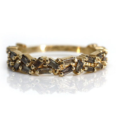 Gold ring featuring an intricate pattern of alternating champagne baguette diamonds and decorative bead accents.