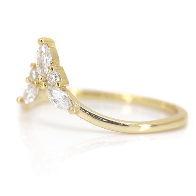 Elegant gold ring featuring a unique design with marquise and round diamonds in a symmetrical arrangement shown from the side.