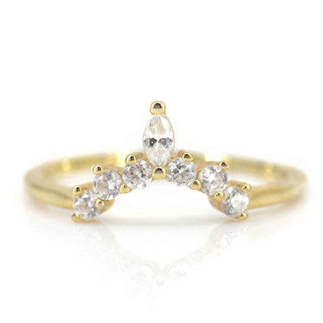 A gold ring featuring a delicate wave design adorned with sparkling round and marquise-cut diamonds. 