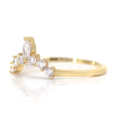 A gold ring featuring a delicate wave design adorned with sparkling round and marquise-cut diamonds shown from the side.