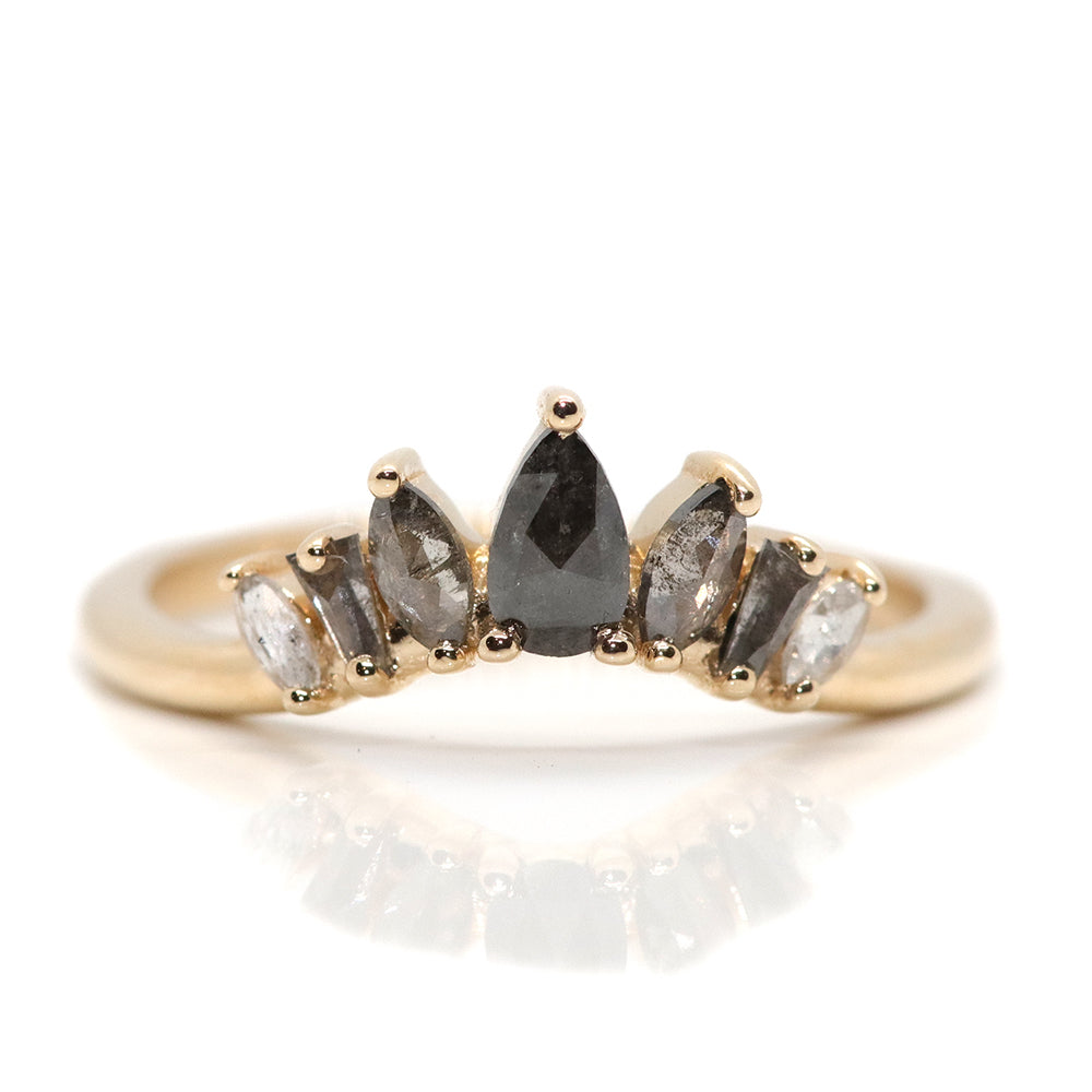 An elegant gold ring featuring a crown-like design with five diamonds in an ombre colour gradient, from black to salt & pepper to white diamonds.