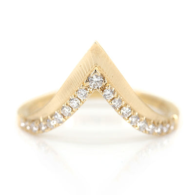 Elegant gold ring with a V-shaped design, encrusted with sparkling diamonds along the band 