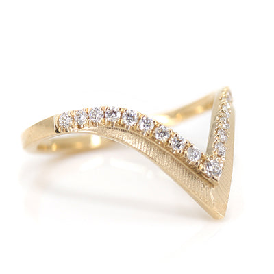Elegant gold ring with a V-shaped design, encrusted with sparkling diamonds along the band shown upside down.