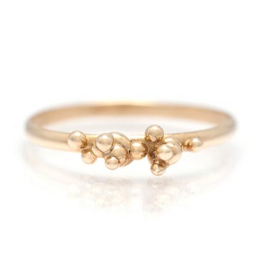 Yellow gold stacking band with organic placed gold bubbles on a white background.